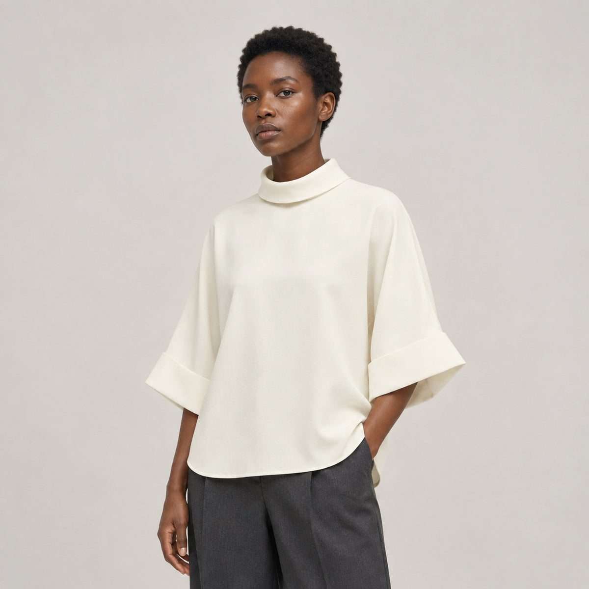 Aster Fold Blouse in Soft Ivory, three-quarter studio view